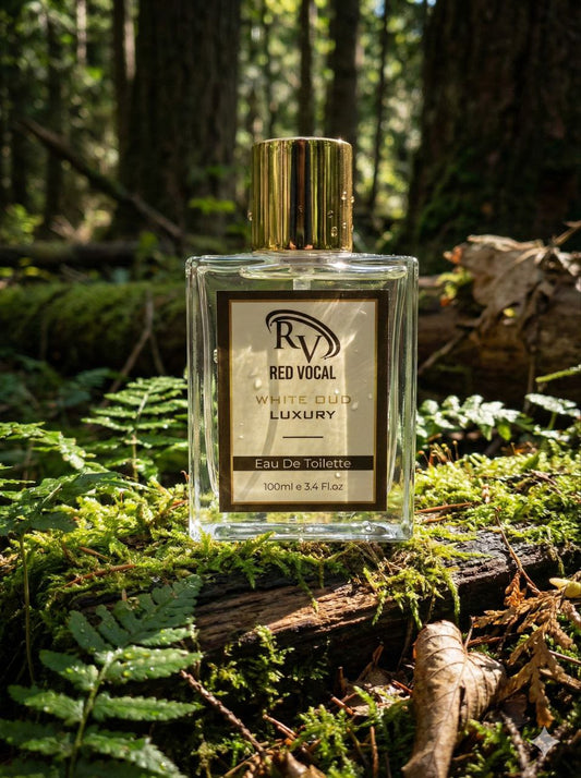 Perfume bottle labeled 'Red Vocal' on a log in a forest setting Red Vocal White Oud Luxury Premium Perfume Eau De Toilette – Unisex 100ml Bold & Long-Lasting Fragrance