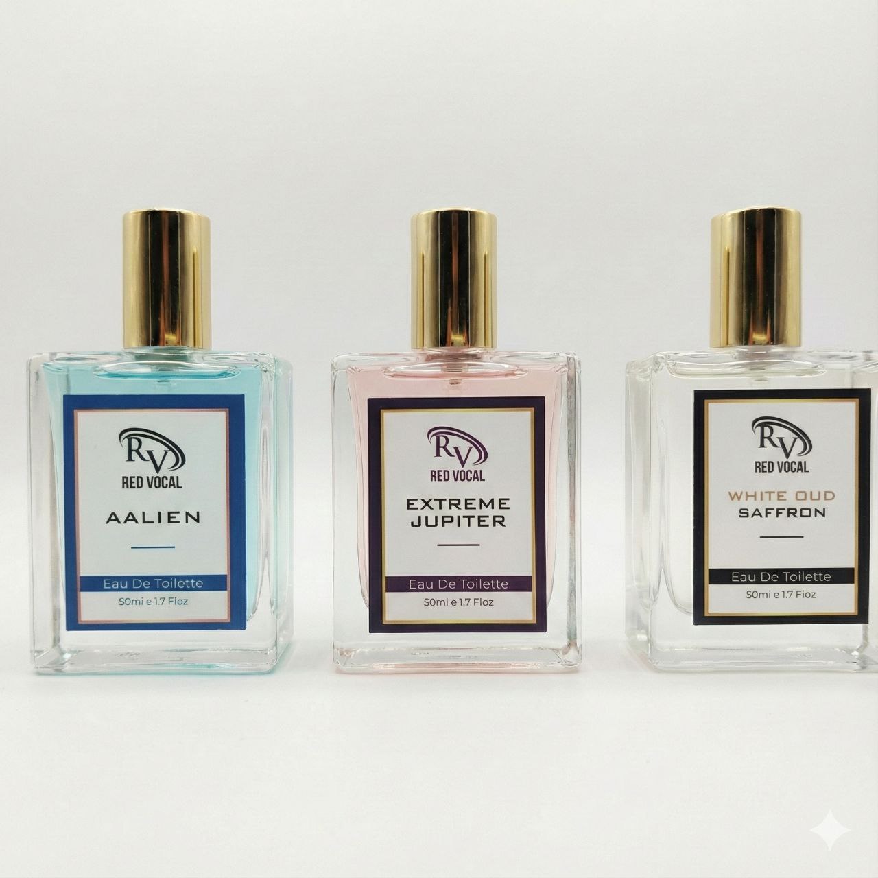 Three perfume bottles from Red Vocal on a white background Three boxes of Red Vocal fragrances on a marble surface with decorative elements.