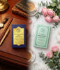 Two men's toiletries packaging on a table with flowers and books Red Vocal Millionaire Men Premium & Floral Romance luxury Perfume Set For Women | Long-Lasting Premium Eau De Toilette | 2×100ml Gift Combo